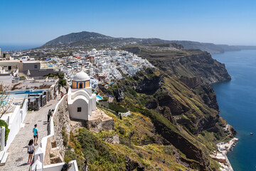 Fototapeta premium Scenic view of Fira, the main town of Santorini, located on the cliffs overlooking the Aegean Sea, Greece