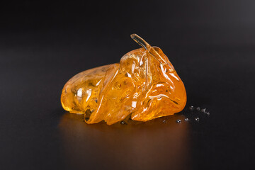 piece of cannabis wax clsoeup. concentrate dab with high thc.