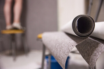 repair and gluing of gray wallpaper in the room