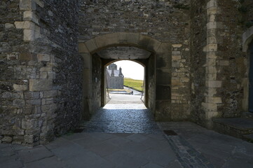 Fototapeta na wymiar A medieval castle entrance or exit protected by a Drawbridge in the UK. 