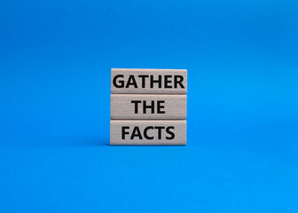 Gather the facts symbol. Wooden blocks with words Gather the facts. Beautiful blue background. Business and Gather the facts concept. Copy space.