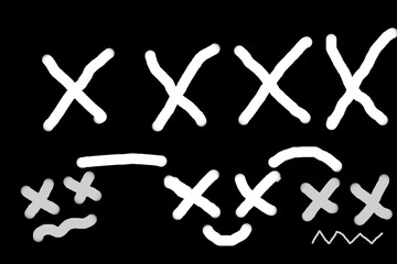 Obraz premium Funny faces on a black background. Children's drawing.