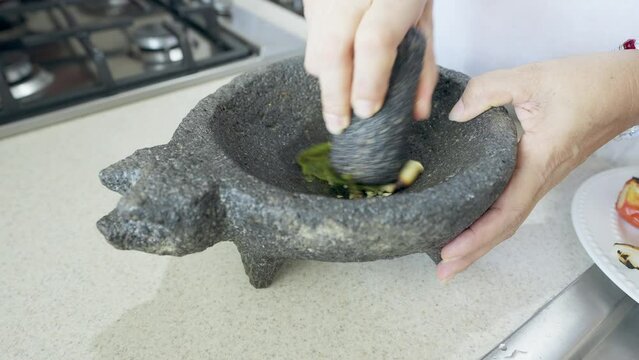 Grinding Jalapeno Peppers in the Traditional Mexican Molcajete