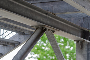 beam architecture: detail of a structure built with steel beams joined with bolting to support a...