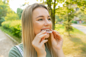 Cute girl with white smile, using removable braces. Dental Treatment, Health Concept