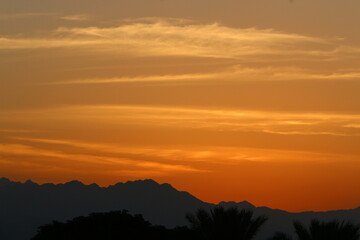 Sunrise at the Dead Sea in Israel. The sun comes out from behind the mountains in Jordan.