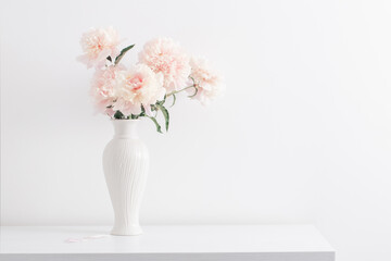 pink peonies in ceramic white vase in white interior © Maya Kruchancova