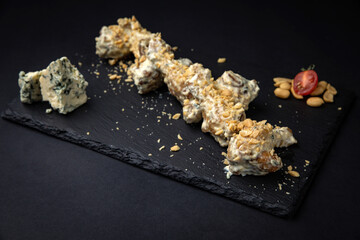 grilled chicken wings with sesame seeds and spices on black background