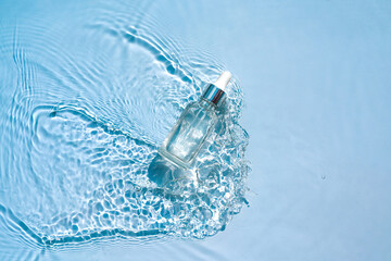 Moisturizing cosmetic product, serum, gel, emulsion in a transparent bottle with a pipette in water...