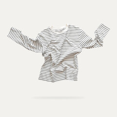 Fashionable trendy flying striped longsleeve, white gray striped shirt isolated on light...