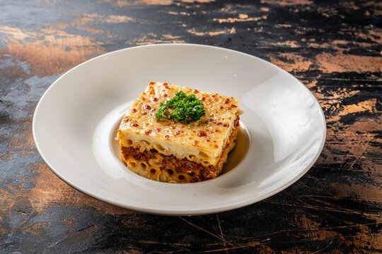 macaroni bechamel served in a dish isolated on dark background side view food