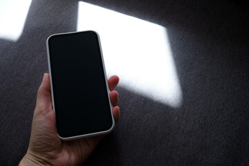 Smartphone close-up on a dark background. Copy space for text and info content to your phone. Focus on your phone screen. Gadget addiction
