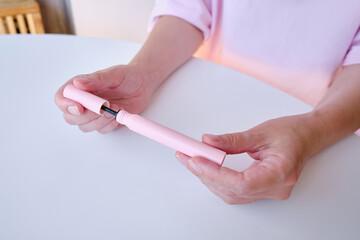 Girl hold mascara. Eyelash brush. Pink tube of mascara. Makeup cosmetics