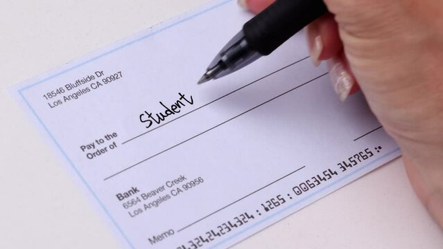 Close-up shot of a check being writen.