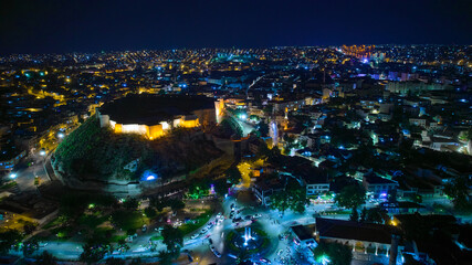 Illuminated Gaziantep Castle and night city lights aerial view