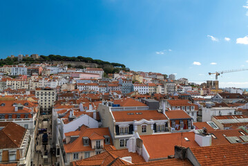 Fototapeta na wymiar Lisboa, Portugal. April 10, 2022: Alfama neighborhood on a summer afternoon and San Jorge castle.
