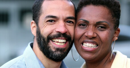 Interracial couple smiling cheek to cheek. Hispanic husband and African wife