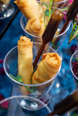rolls of pancakes with stuffing on the buffet