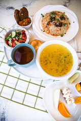chicken soup with salad and bread on a bell tablecloth