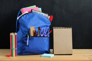 Preparation for school: blue backpack and stationery.