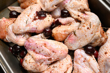 Marinated chicken wings with sweet cherry on a rustic wooden background