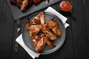 appetizing chicken wings grilled barbecue with spices and vegetables until crisp