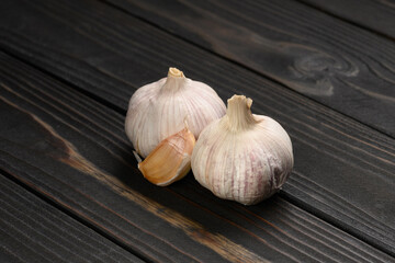 Fresh garlic on a rustic wooden background.