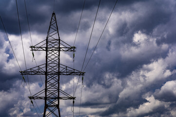 Terrible dark clouds over high voltage lines