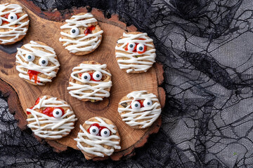 Mummy cookies for Halloween party. Thematic background on Halloween. Creative food idea for kids