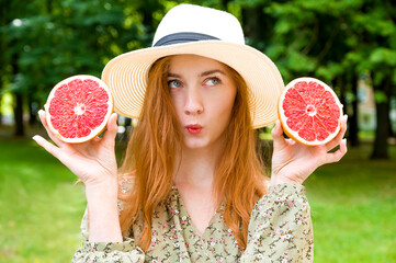 Sunny summer portrait of beautiful girl in the park having fun. Vitamins concept