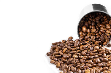 Fototapeta premium Roasted coffee beans in metal cup isolated on a white background.Copy space