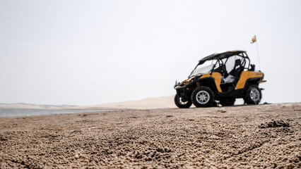 Fototapeta na wymiar Blurred silhouette of buggy car un the desert in Qatar