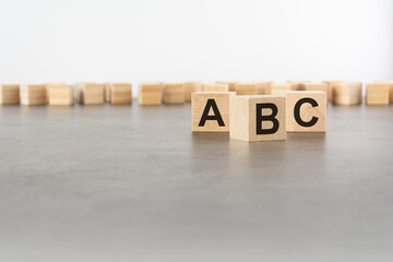 letters ABC is made of wooden blocks on gray background