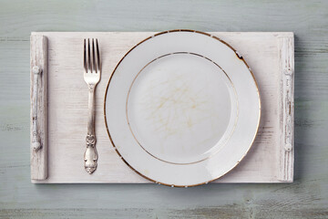 Vintage white dish with a fork on a white wooden tray on a blue table