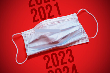 A new jump in the incidence of the Omicron strain. Lettering 2022 2023 2024 and medical mask. The...