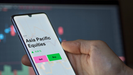 Asia pacific equities etf fund on a screen. A phone shows the prices of Asia Pacific Equities