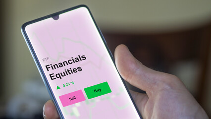 An investor's analizing the financials equities etf fund on a screen. A phone shows the prices of Financials Equities