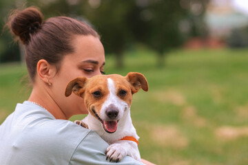 Woman in casual clothes hugging her favorite fluffy trained purebred Jack Russel Terrier dog...