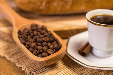 table with coffee cup and scoop of coffee beans.
