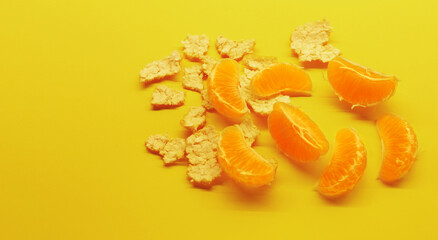 Peeled clementines on a yellow background