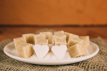 sugar cubes on black backround. Sugar is unhealthy nutrition and leads to obesity, diabetes, dental...