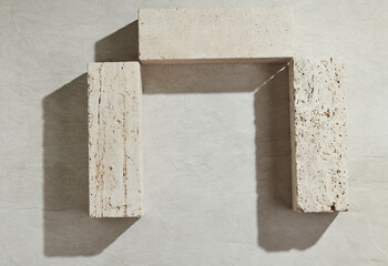 Flatlay minimal natural stone, marble or travertino surface background with block travertino stones. Template for showcase, presentations, branding, web desing, posts.