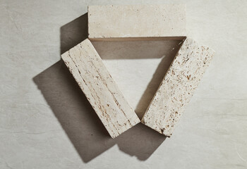 Flatlay minimal natural stone, marble or travertino surface background with block travertino...
