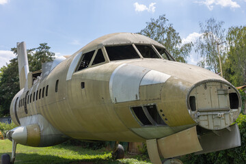 Fototapeta na wymiar Old abandoned airplane wreckage. Vintage green aeroplane wreck. 
