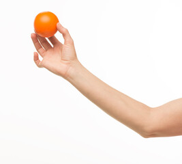 hand holding orange sponge ball isolated