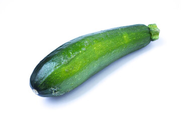 green zucchini lies on a white background