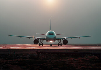 commercial airplane preparing for takeoff on the runway, front view