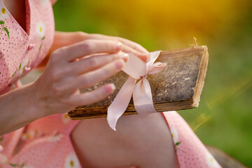 woman holding vintage notebook outside