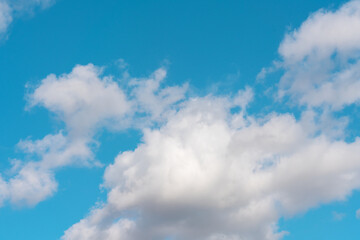 white cirrus, feathery clouds  against spring bright blue cloudy sky  on sunny day in England