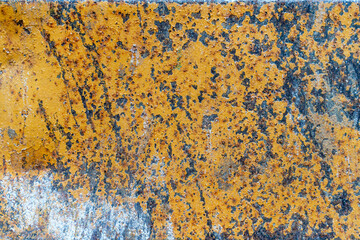 Grunge rusty metal texture background with patches of old yellow paint